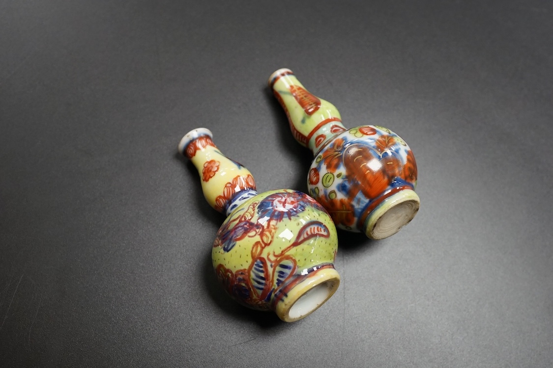 Two Chinese famille rose cups, Yongzheng period and two miniature clobbered vases, largest 6cm high